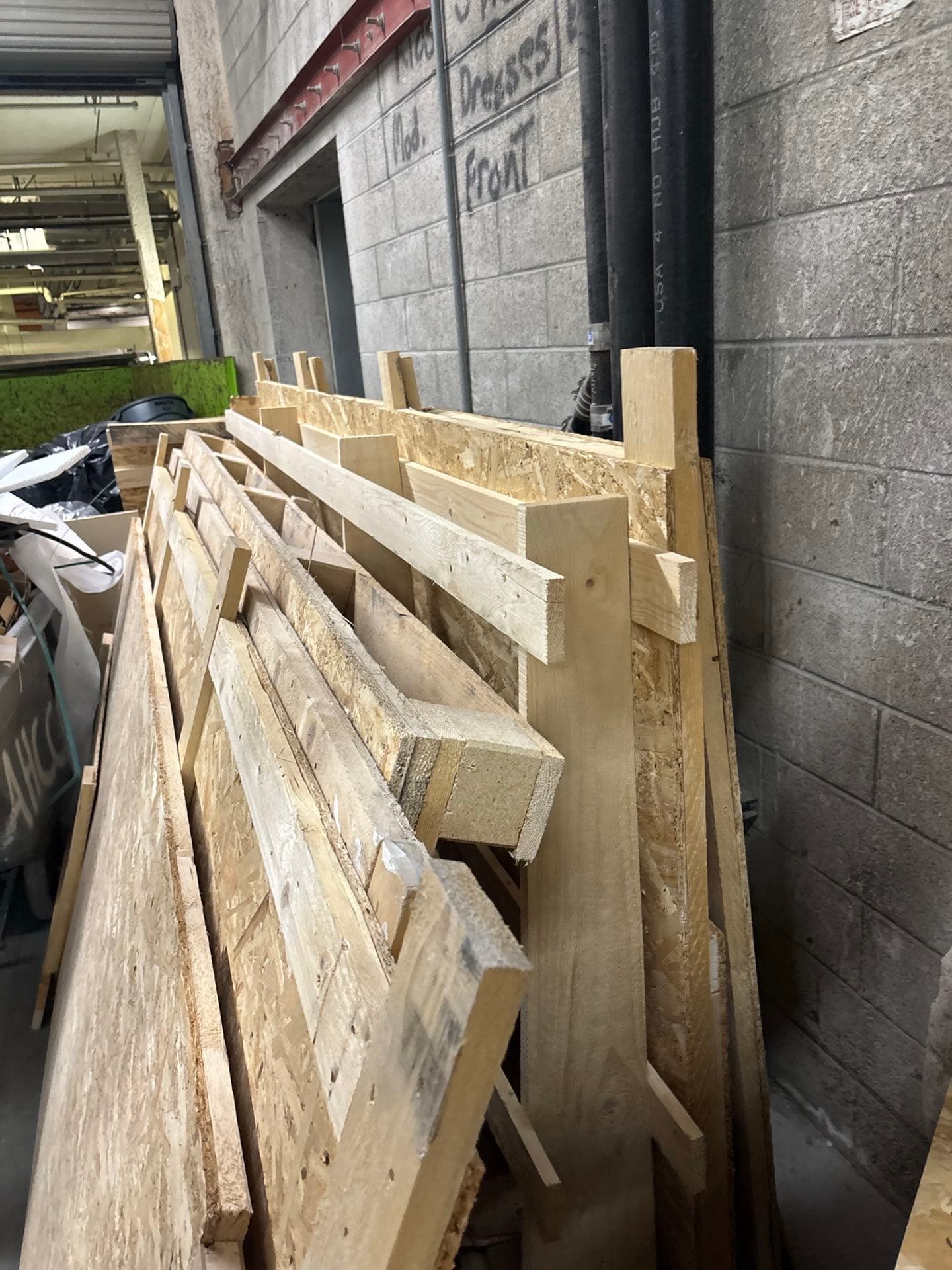 Stack of plywood and lumber ready for JunkMD+ construction debris haul-away in San Diego