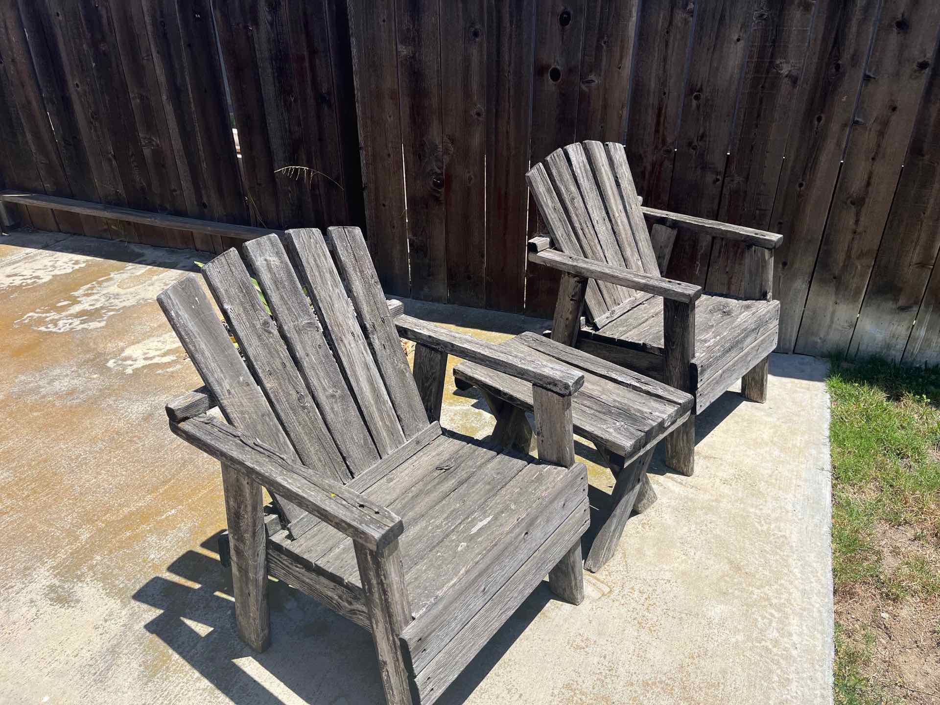 Weathered wooden adirondack chairs on a San Diego patio before JunkMD+ deck cleanout
