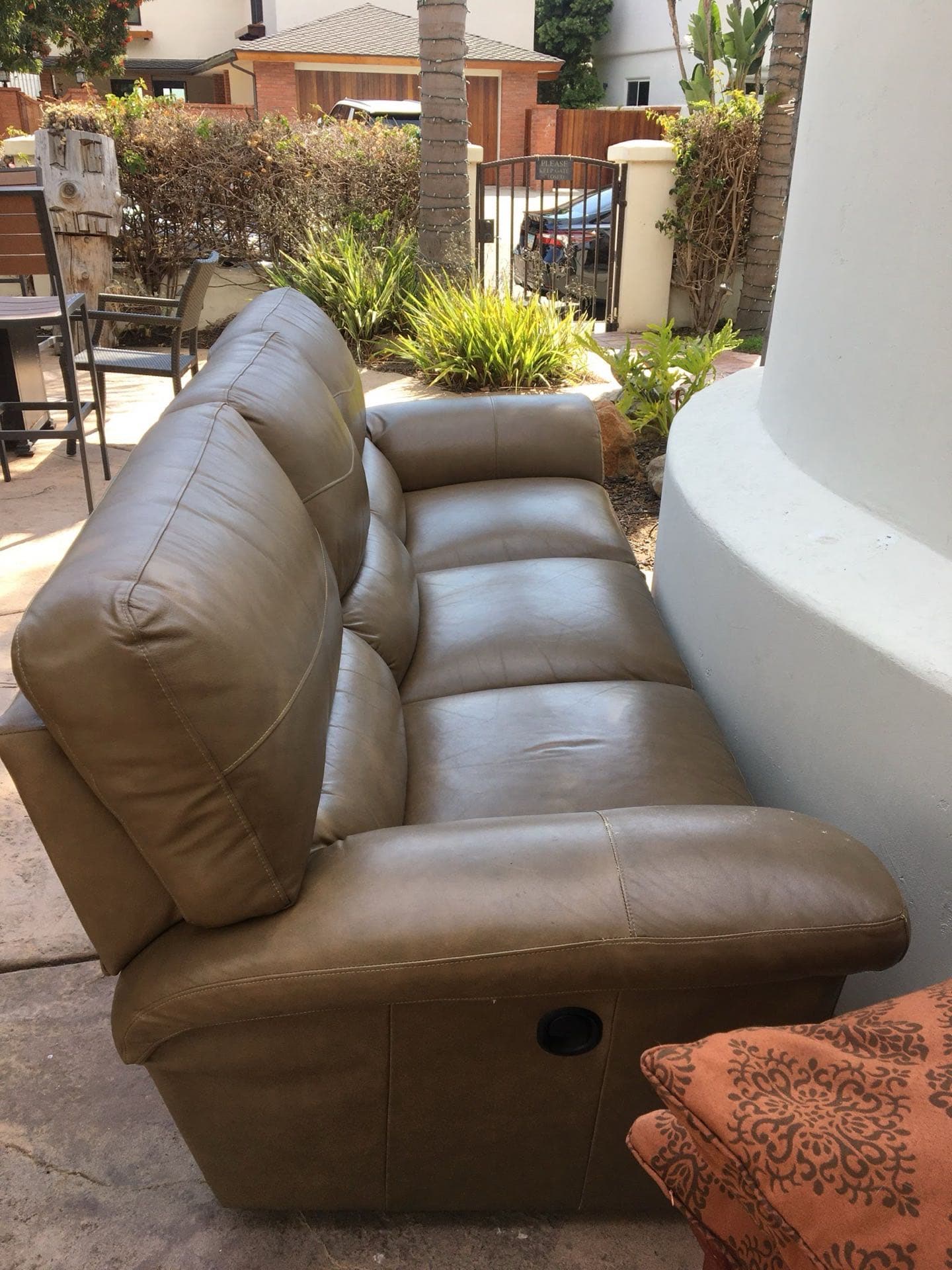Brown leather couch at the curb awaiting JunkMD+ couch removal in San Diego