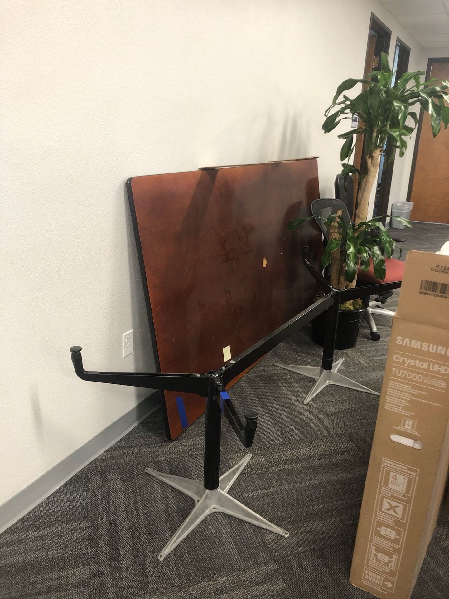 Office tables and a TV box prepped for JunkMD+ furniture cleanout in San Diego