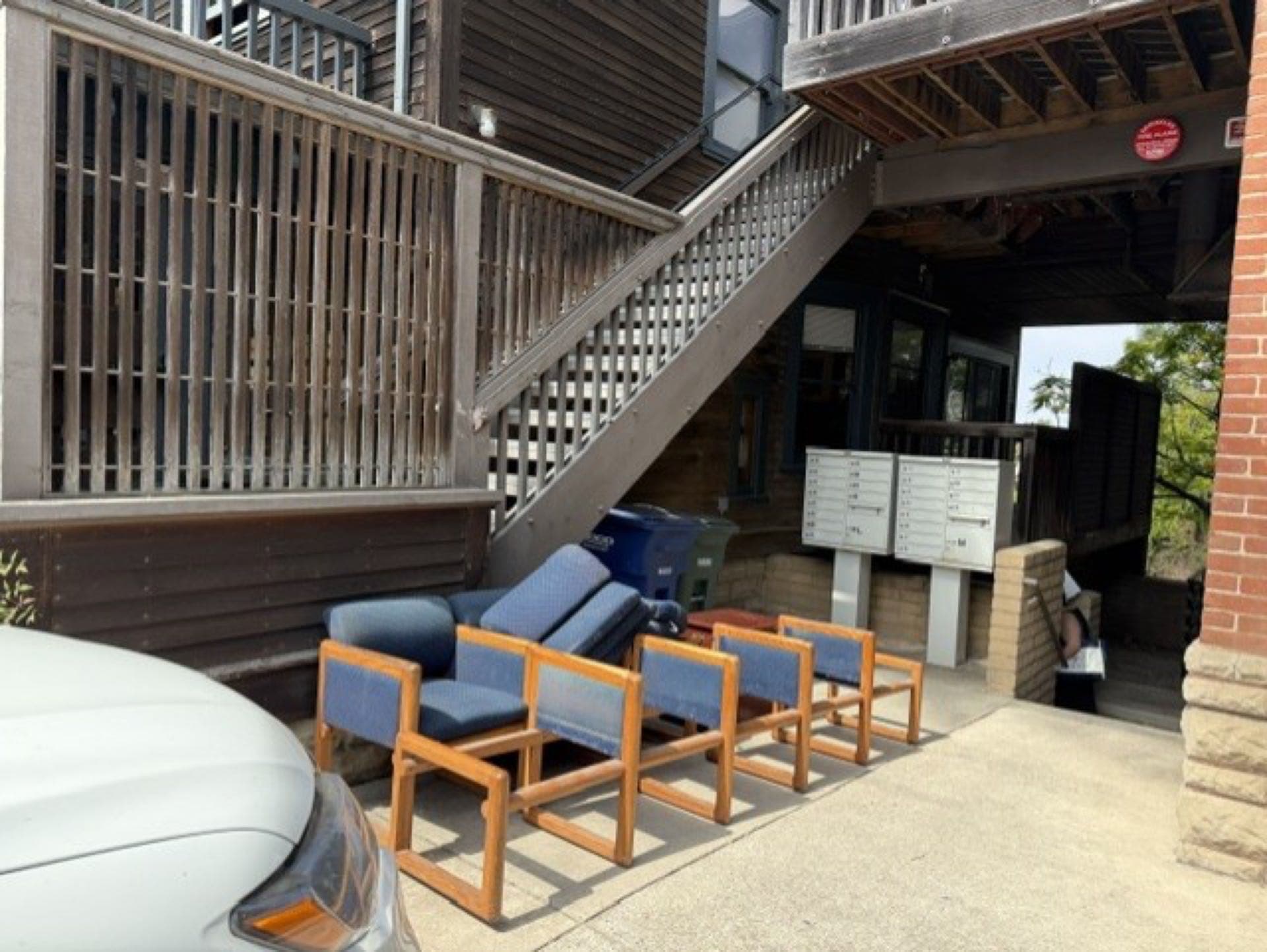 Row of office chairs from an apartment furniture cleanout being staged for JunkMD+ pickup in San Diego