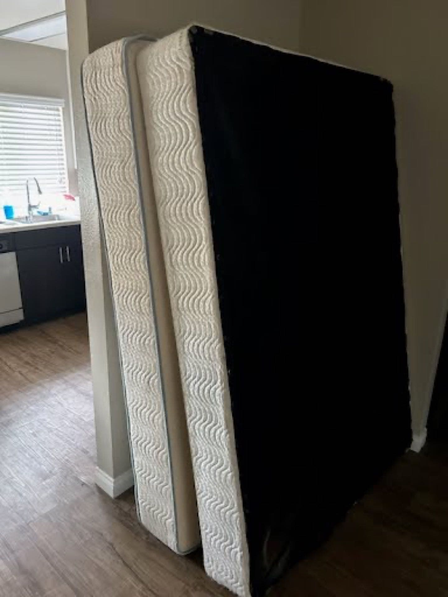 Stacked mattresses staged for JunkMD+ mattress disposal in a San Diego bedroom
