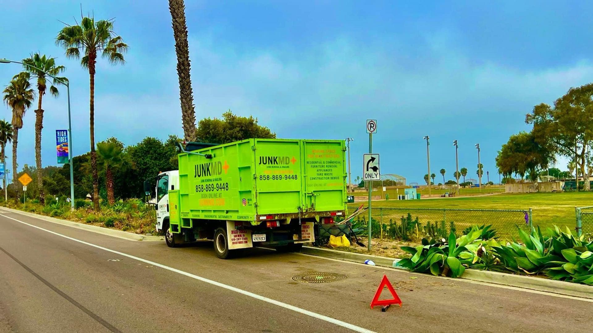 JunkMD+ green junk-removal truck on a Coronado, San Diego route